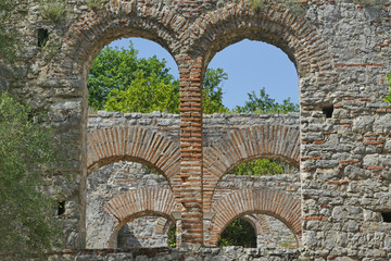 Remains of stone arch cathedral windows, Butrint ancient Greek and Roman city, Albania