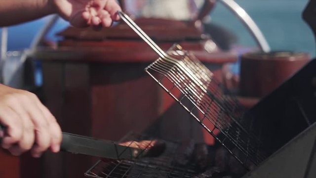 A close-up shot of Kebabs being cooked on a BBQ on a boat at sea