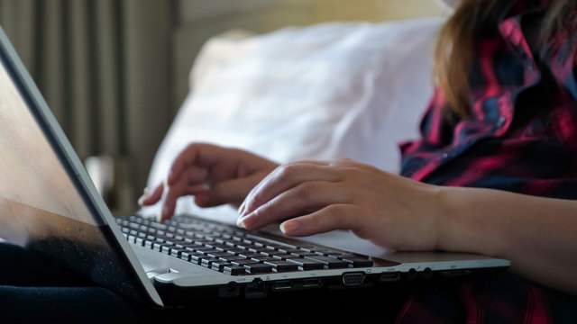 Girl Freelancer Hands Type On Black Laptop Keyboard In Bedroom Close-up