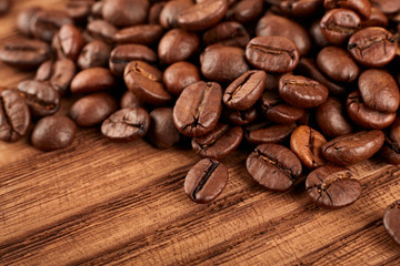 Roasted coffee beans on a white background. The texture of the coffee. An invigorating drink.