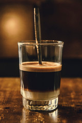 Vietnamese Milk Coffee on Wooden Table. Traditional Hot Drinks in Vietnam. Close-up Vietnamese Drip Coffee and Ice mug served with milk, Iced black coffee.