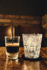 Vietnamese Milk Coffee on Wooden Table. Traditional Hot Drinks in Vietnam. Close-up Vietnamese Drip Coffee and Ice mug served with milk, Iced black coffee.