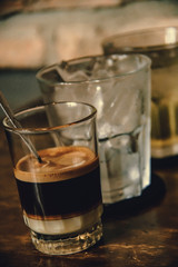 Vietnamese Milk Coffee on Wooden Table. Traditional Hot Drinks in Vietnam. Close-up Vietnamese Drip Coffee and Ice mug served with milk, Iced black coffee.