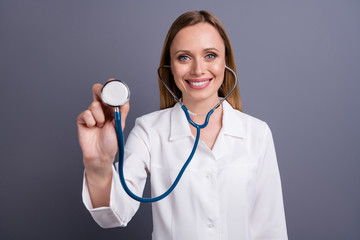 Close-up portrait of nice attractive cheerful blonde girl experienced doc examining lungs pandemic epidemic ambulance pneumonia test isolated over grey violet pastel color background