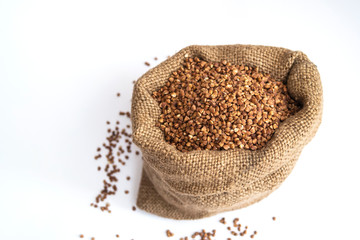 Buckwheat grain in a sack on a white isolated background