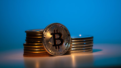 Silver Bitcoin On the table with onother currency on the neon background