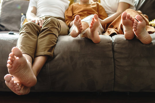 Barefoot family sitting on the sofa
