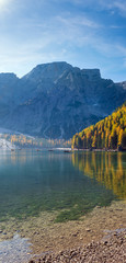 Fototapeta premium Autumn peaceful alpine lake Braies or Pragser Wildsee, South Tyrol, Dolomites Alps, Italy, Europe. Picturesque traveling, seasonal and nature beauty concept scene. People unrecognizable.