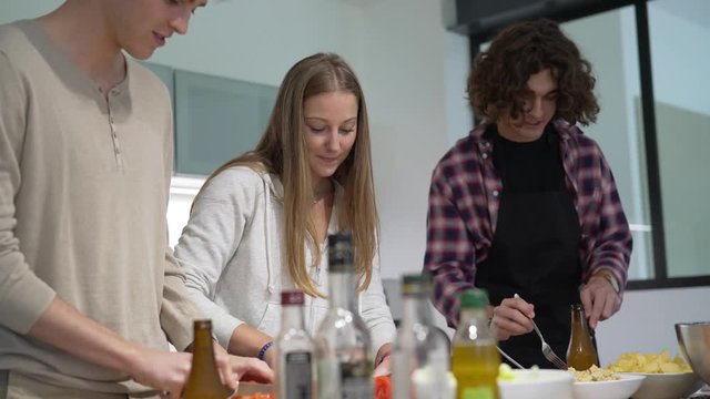 Flatmates cooking together at home