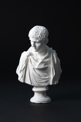 plaster figure in black background