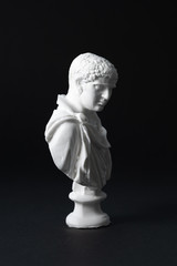 plaster figure in black background