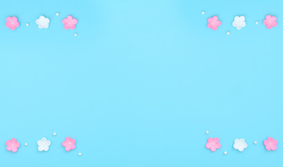 Pink and white flowers made of foamiran on blue background. Mother day, Valentine day, Wedding, Birthday concept. Greeting or invitation card. Flat lay with copy space.