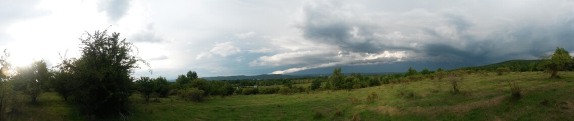 stormy clouds over green forest in summer season
