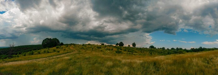 stormy clouds over green forest in summer season
