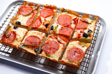 detroit pizza on an iron tray. selective focus