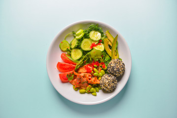 Fresh and organic vegetable salad with raw veggies - tomatoes, cucumbers, avocado. Flat lay, copy space banner.