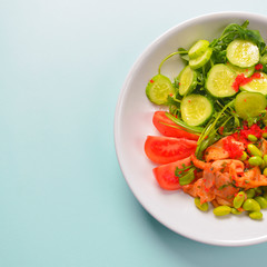Fresh and organic vegetable salad with raw veggies - tomatoes, cucumbers, avocado. Flat lay, copy space banner.