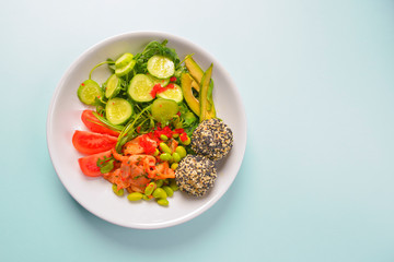 Fresh and organic vegetable salad with raw veggies - tomatoes, cucumbers, avocado. Flat lay, copy space banner.