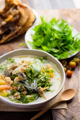 Northern Thai food (Kang Pak Wan Pa), Spicy local Thai vegetable soup with dry fish and glass noodles in a bowl on wooden background, Local Thai food