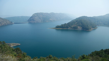 Misty morning mountain in a dam.
