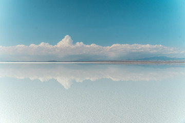 Blue Sky Clouds Mirror Reflection. Cloud Sky reflect on water surface of Bolivia's Salt Flats....