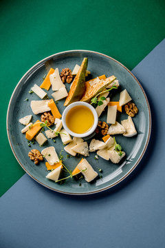 Cheese plate honey parmesan camambert pear melon microgreen cutting cuisine dish