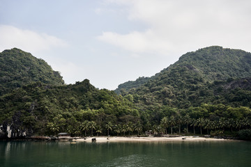 Houses on the idyllic beach at the Ha Long Bay, Vietnam.