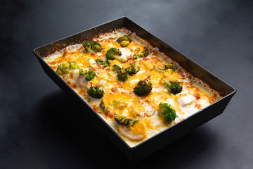 detroit pizza on an iron tray on a dark background. selective focus