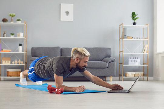 Workout Exercise Fitness Online Video Call. Man Doing Exercises Of An Online Fitness Course Training In A Laptop Video Chat At Home.