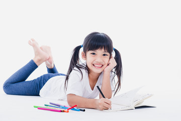 A young asian girl drawing a picture. On white
