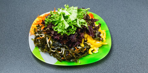 Ingredients for making salad on a green plate. © bearok