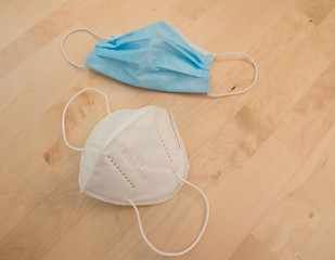 surgical and ffp2 mask on wooden table