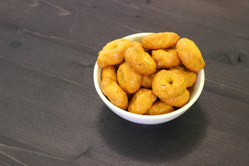 Hard ring-shaped bakery italian snack product with tomato and odoriferous herbs.