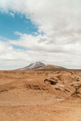 Rocky landscape mountain background. Dry, Barren desert, snowcapped mountains wilderness. Mountain range view. Salt Flats of Uyuni, Bolivia. Copy space, Rocks, blue sky, nature, hiking, sand dust