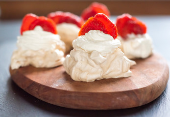gourmet dessert pavlova strawberry on a wooden background