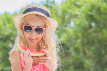 Portrait of a young blonde little girl with watermelon, Summertime fun.