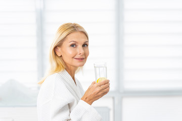 Attractive mature woman with a glass of drink