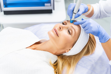 Female patient undergoing a skin cleansing procedure