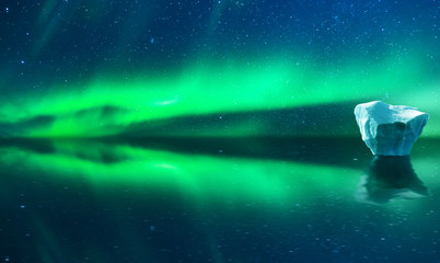 Aurora northern lights with reflection on clear water