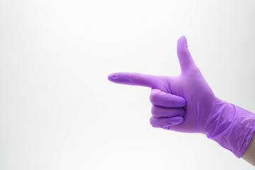 Medical, latex, nitrile glove on a white background shows the finger straight, pointing forward.