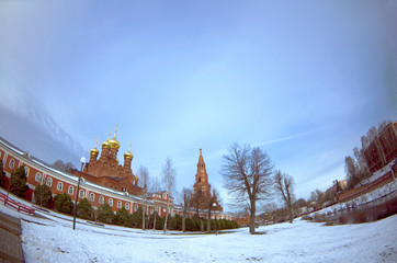 The Chernigovsky skete in Sergiev Posad, monastery, unique, central Russia, winter, blue sky, pond with ducks, fisheye lens, distored perspective
