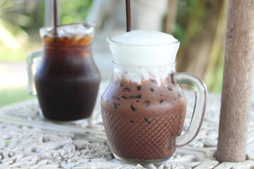Americano coffee in a glass on the table in a cafe in the garden