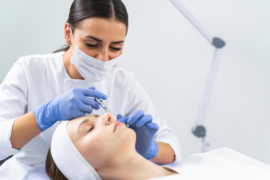 Dermatologist Injecting A Cheek Filler To A Woman