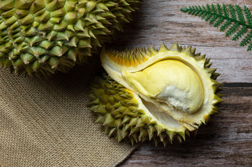 Durian on sack and Delicious fresh Ripe durian tropical fruit on the wooden background, king of...