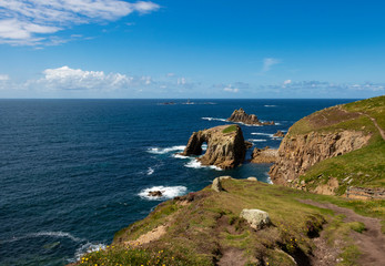 A beautiful view of Cornish coastline with cliffs and rock formations in summer.