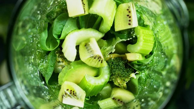 Green fresh smoothie blended in blender, top view. Healthy eating concept. Super slow motion filmed on high speed cinematic camera.