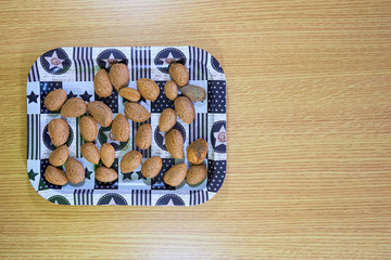 almonds on tray on wooden table