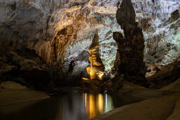 Stalactites and stalagmites and the underground river in a cave