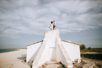 Young couple on the roof of the house on the sea beach