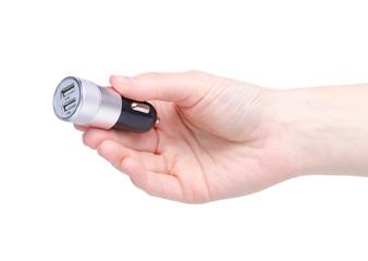 Car USB power supply in the cigarette lighter in hand on a white background isolation
